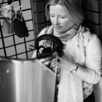 Esther Wane in recording studio adjusting headphones before narrating an audiobook.