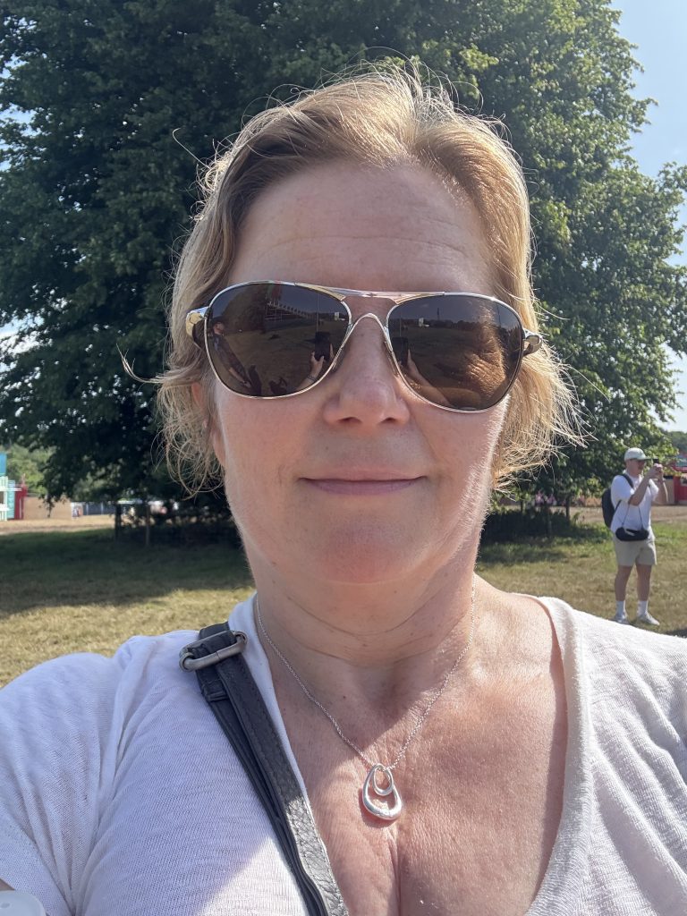 Esther Wane taking a selfie outside with sunglasses on